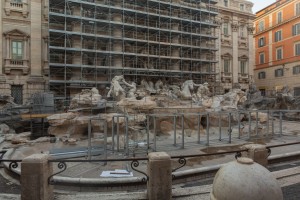 A vacation plan ruined when tourists discover one destination, the Trevi Fountain in Rome, Italy is under construction, covered in scaffolding.